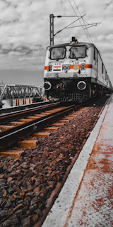 white and black train on rail tracks