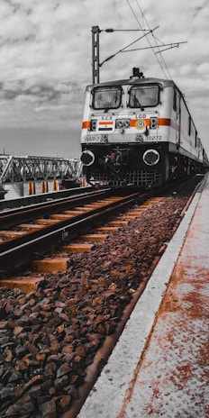 white and black train on rail tracks
