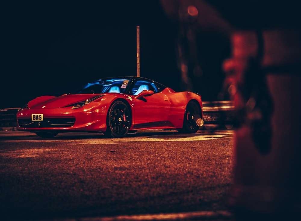 red ferrari 458 italia on road during night time