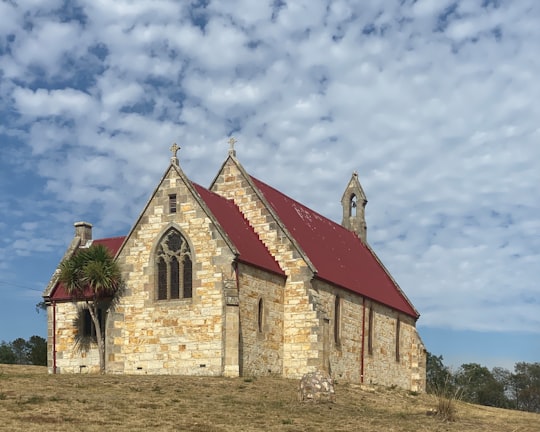 red and white concrete building under blue sky during daytime in Fingal TAS Australia