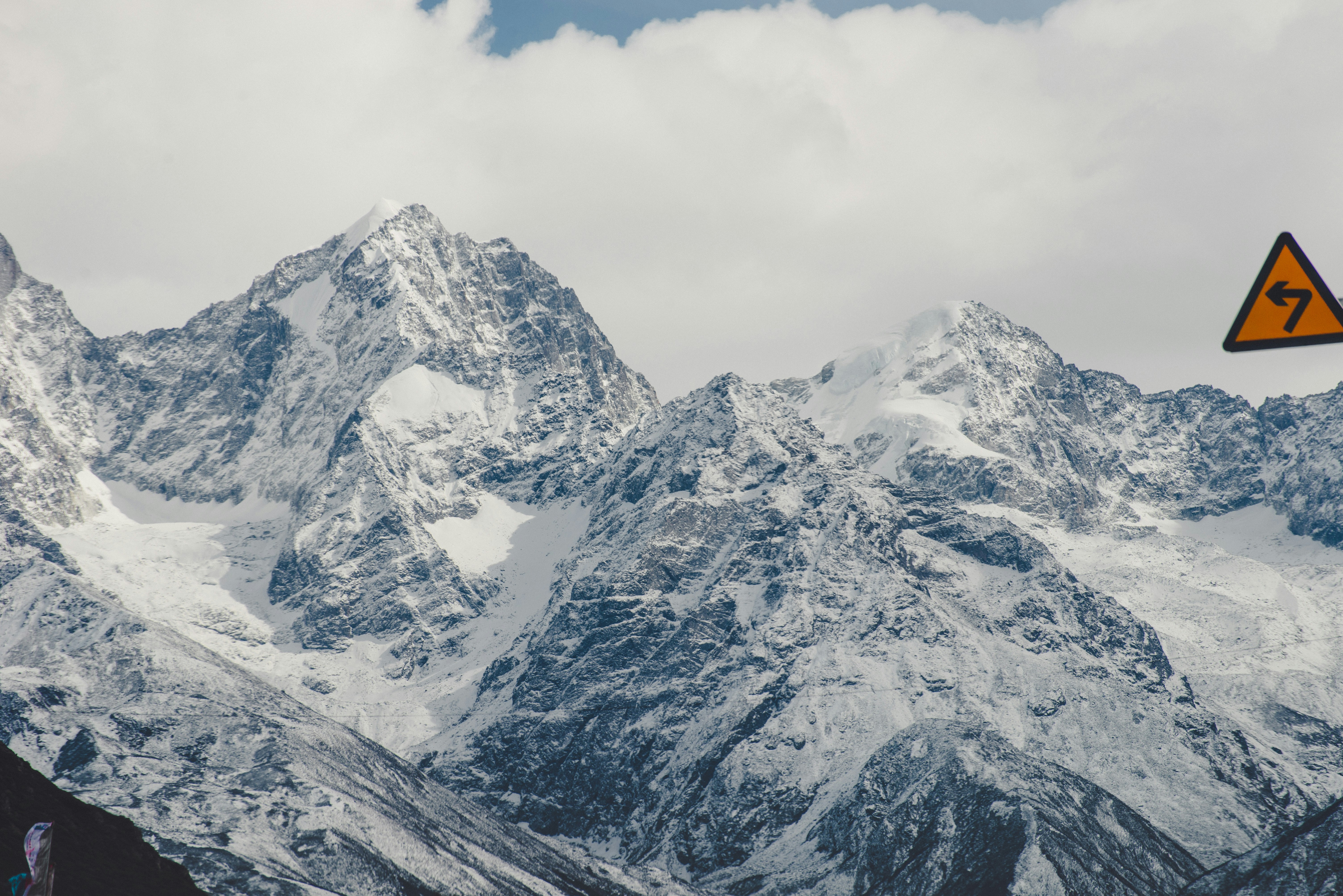 snow covered mountain under cloudy sky during daytime