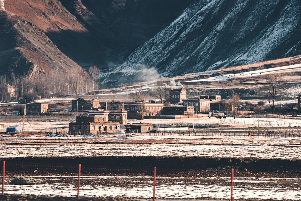 brown and white train on rail tracks near mountain during daytime