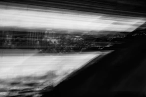 Still from a video showing dynamic motion blurred in monochrome tones.