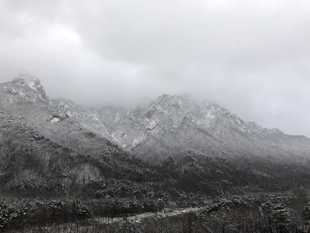 snow covered mountain under cloudy sky during daytime