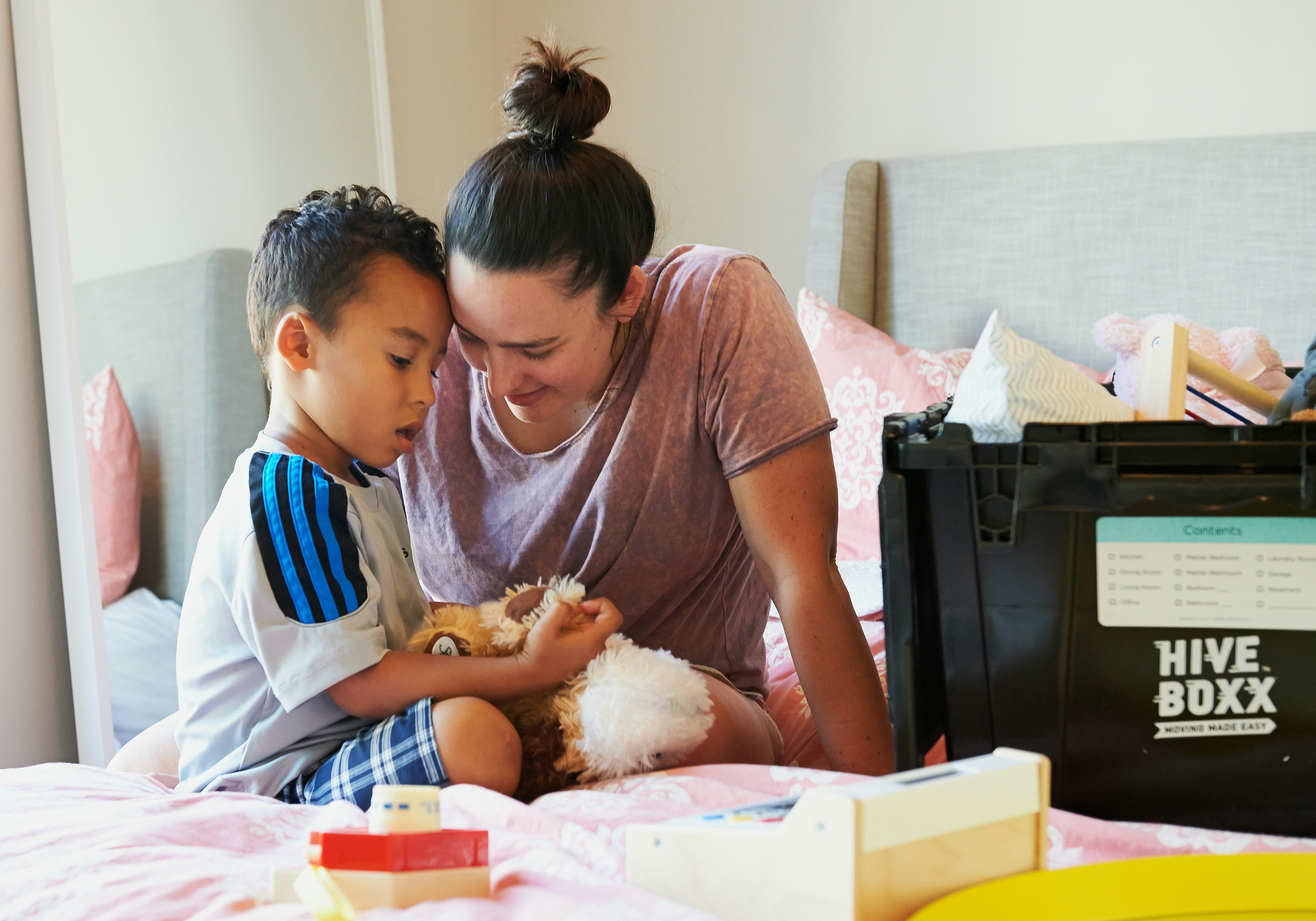Caregiver carrying a smiling baby in a warm embrace