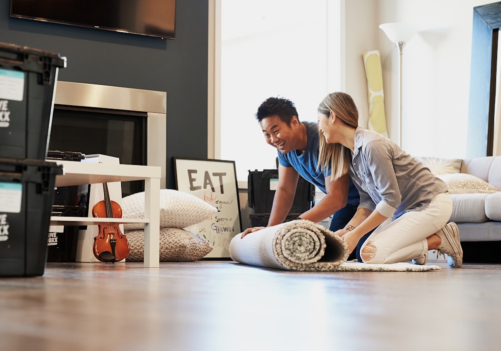 man in blue t-shirt sitting on floor