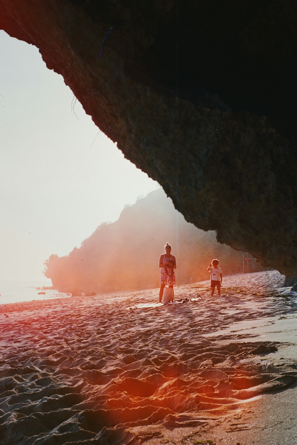 woman in red bikini standing on brown rock formation during daytime