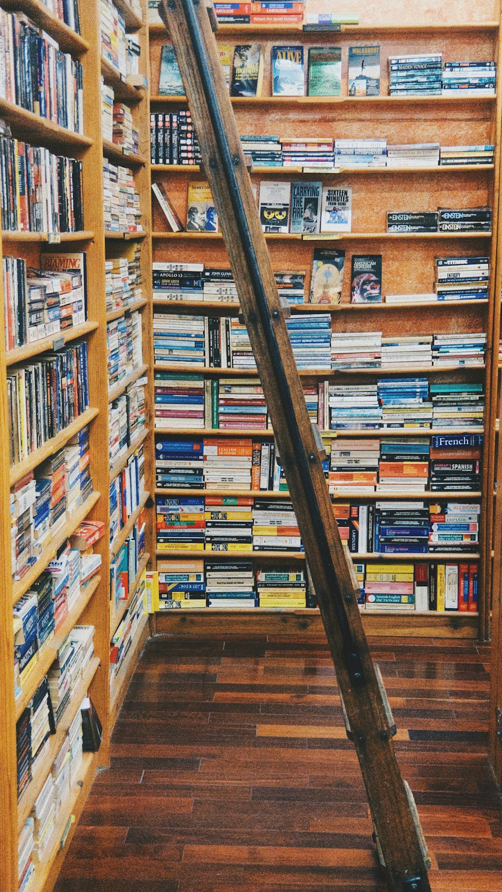 books on brown wooden shelf