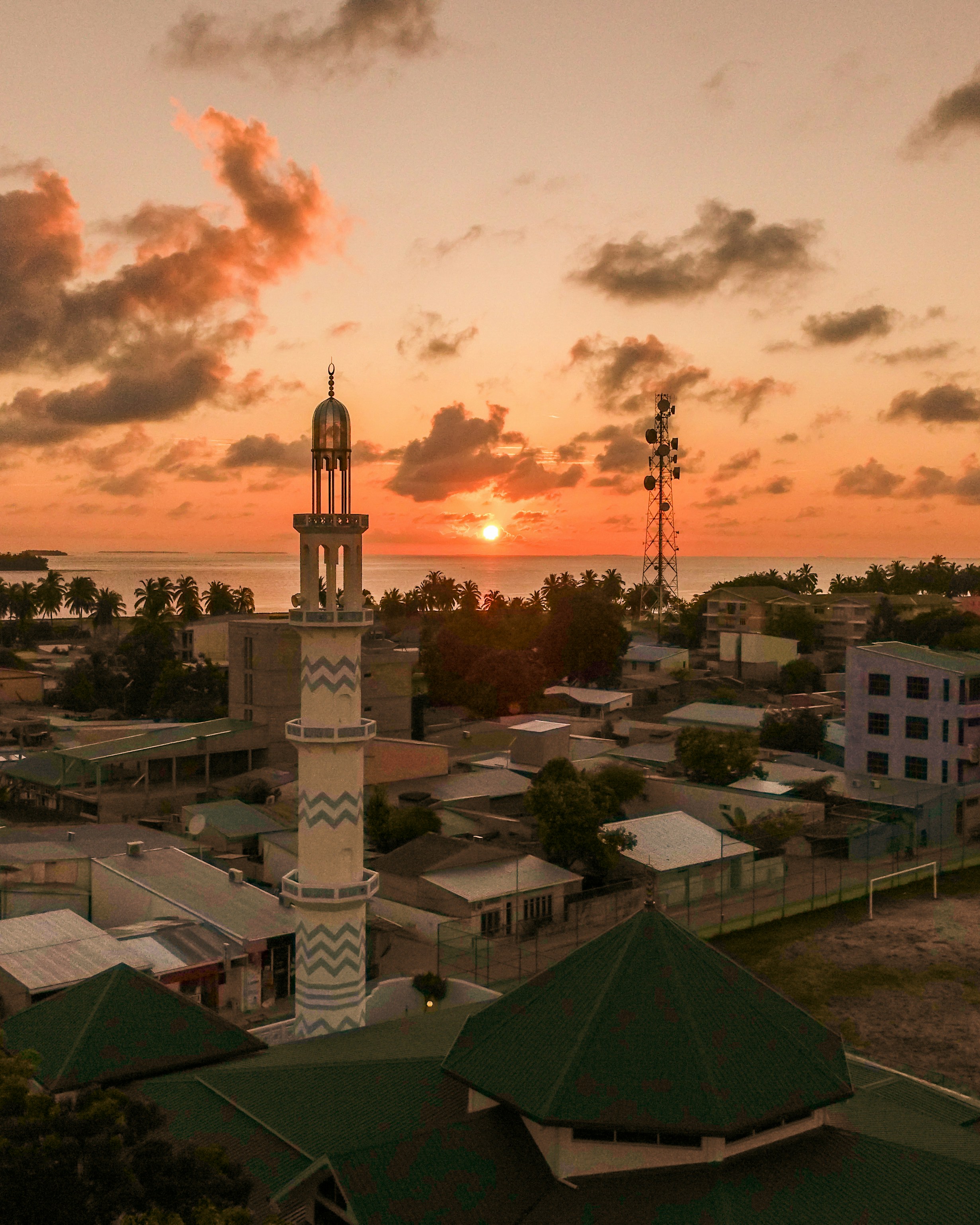white and green concrete building under cloudy sky during daytime