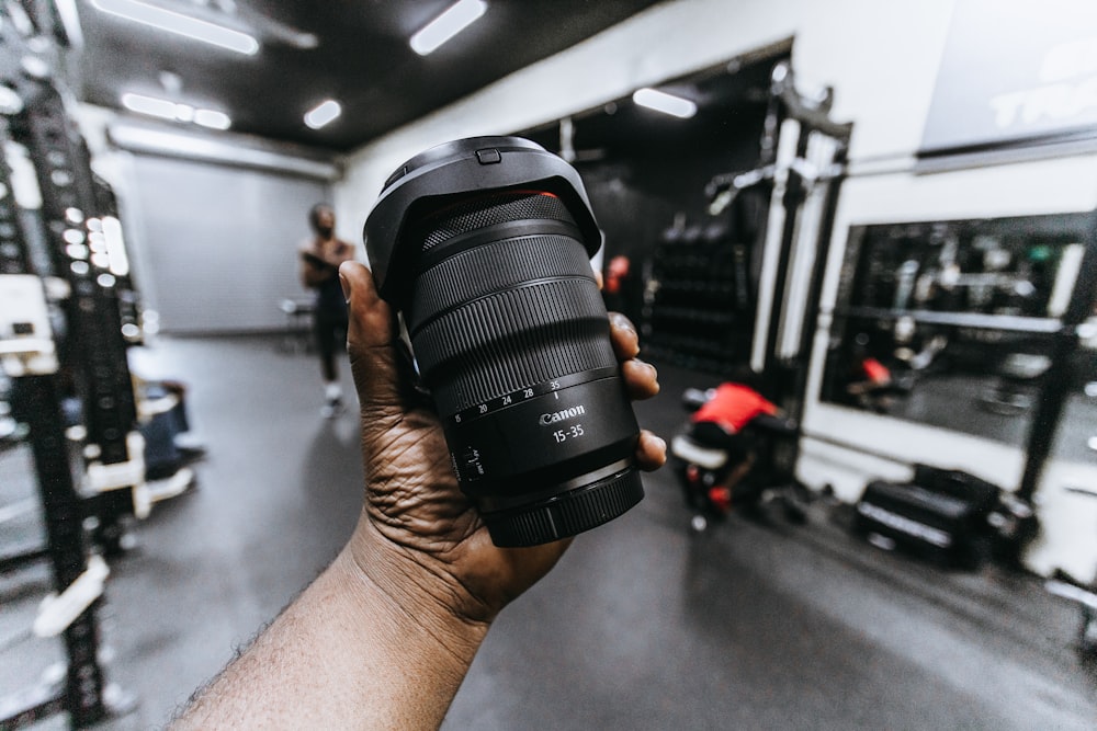 person holding black dslr camera