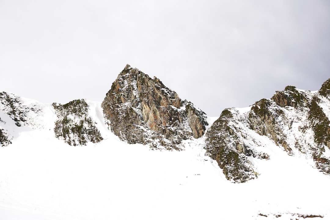 snow covered mountain under white sky during daytime