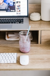 clear plastic cup with white and blue straw