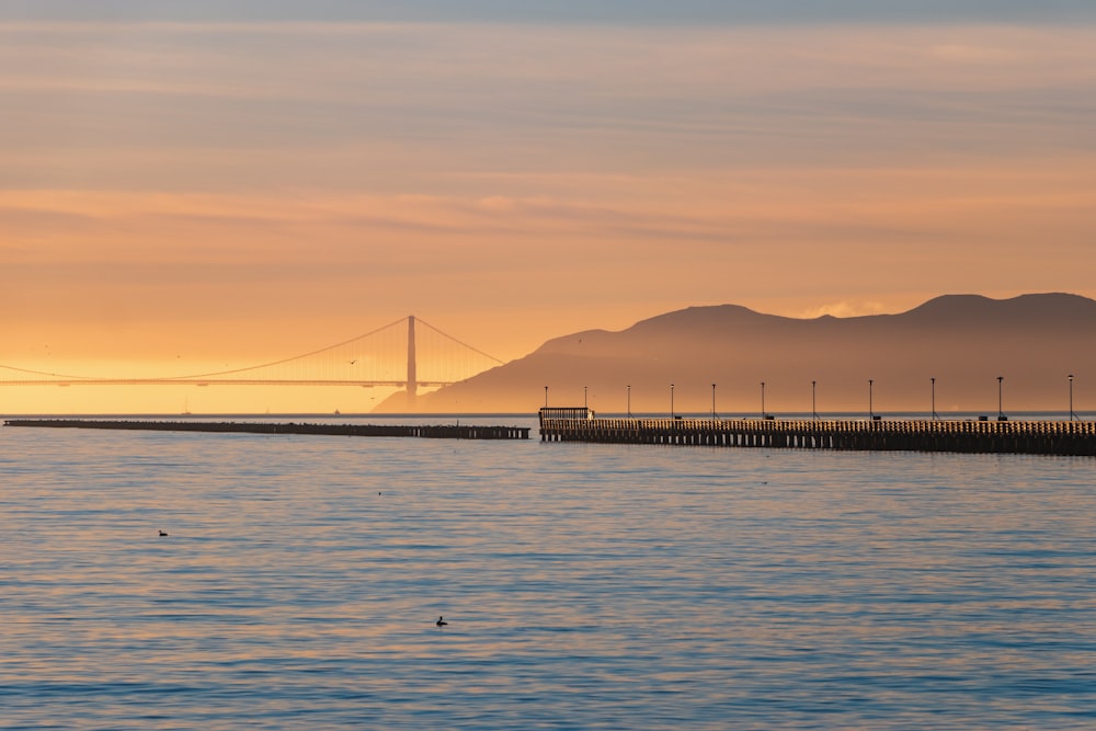 bridge over the sea during sunset