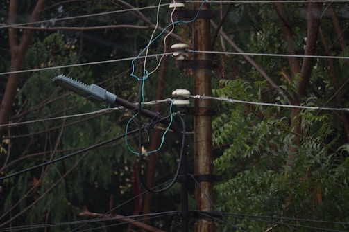 Technicians installing smart grid equipment on power poles.
