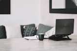 Elegant workspace with a laptop, coffee cup, and import documents on a minimalist desk