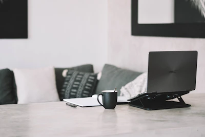 A cozy workspace with minimalistic paper products and a cup of coffee
