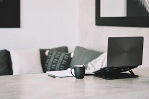 Elegant workspace with a laptop, coffee cup, and import documents on a minimalist desk