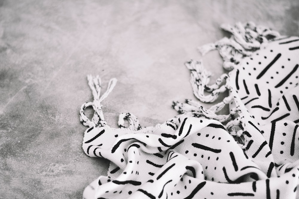 white and black animal skeleton on gray textile