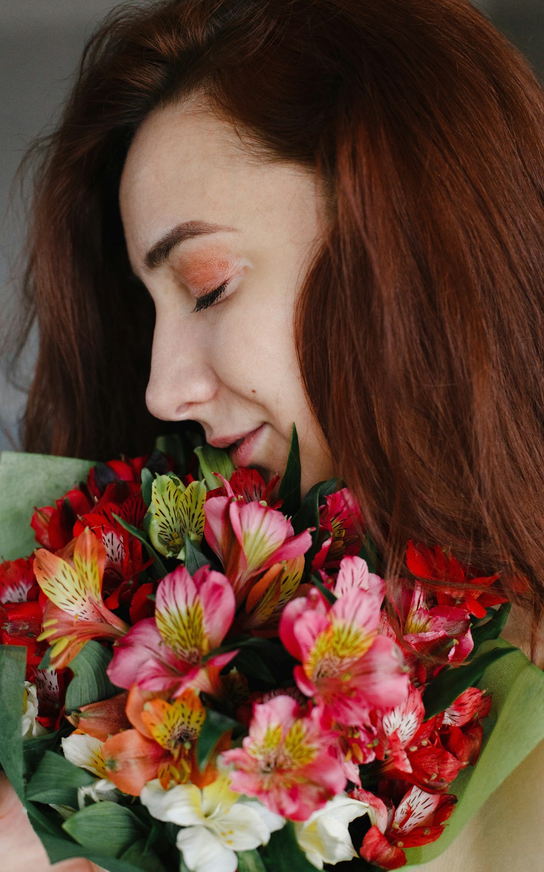 woman holding bouquet of flowers