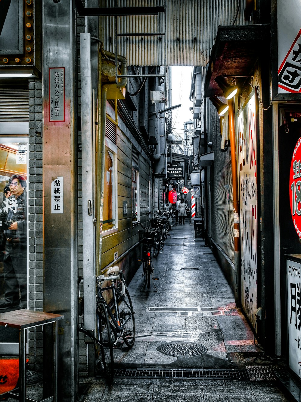 black bicycle parked beside brown concrete building during daytime