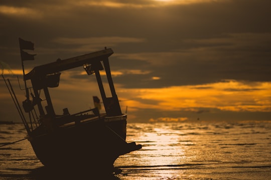 silhouette of boat on sea during sunset in Chonburi Thailand