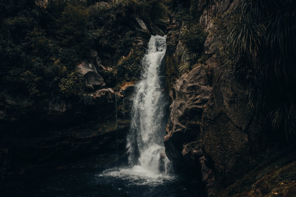 waterfalls in brown rocky mountain during daytime