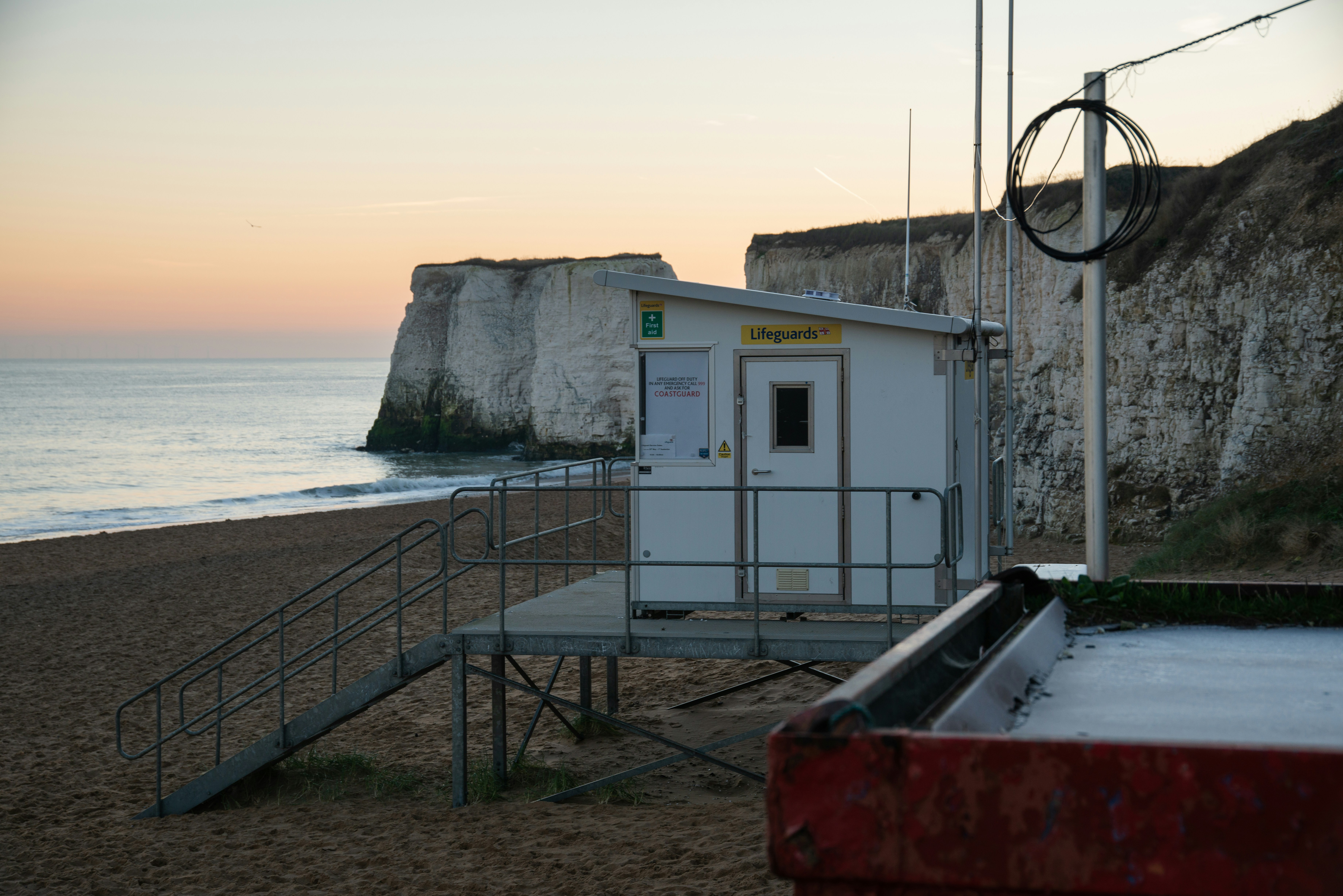 Gebäude aus weißem und rotem Beton in der Nähe des Meeres tagsüber