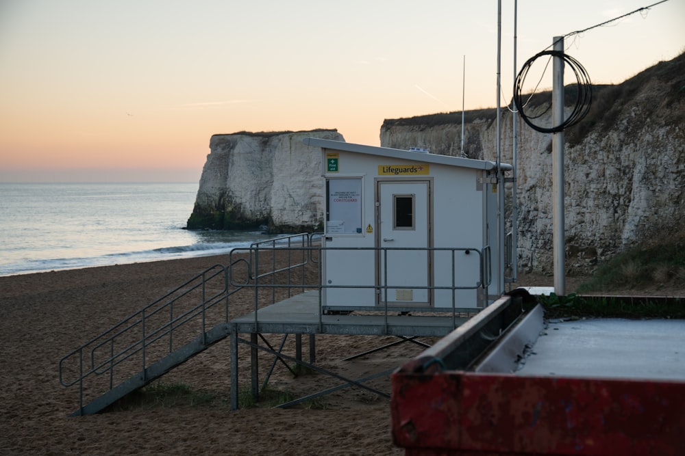 white and red concrete building near sea during daytime