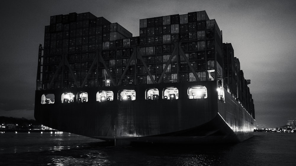 grayscale photo of a man in a boat