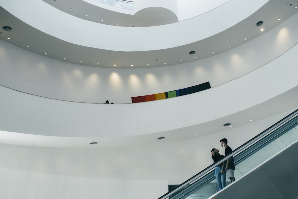 people walking on white and gray concrete building