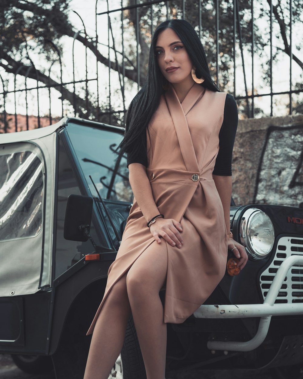 woman in brown long sleeve dress standing beside white car during daytime
