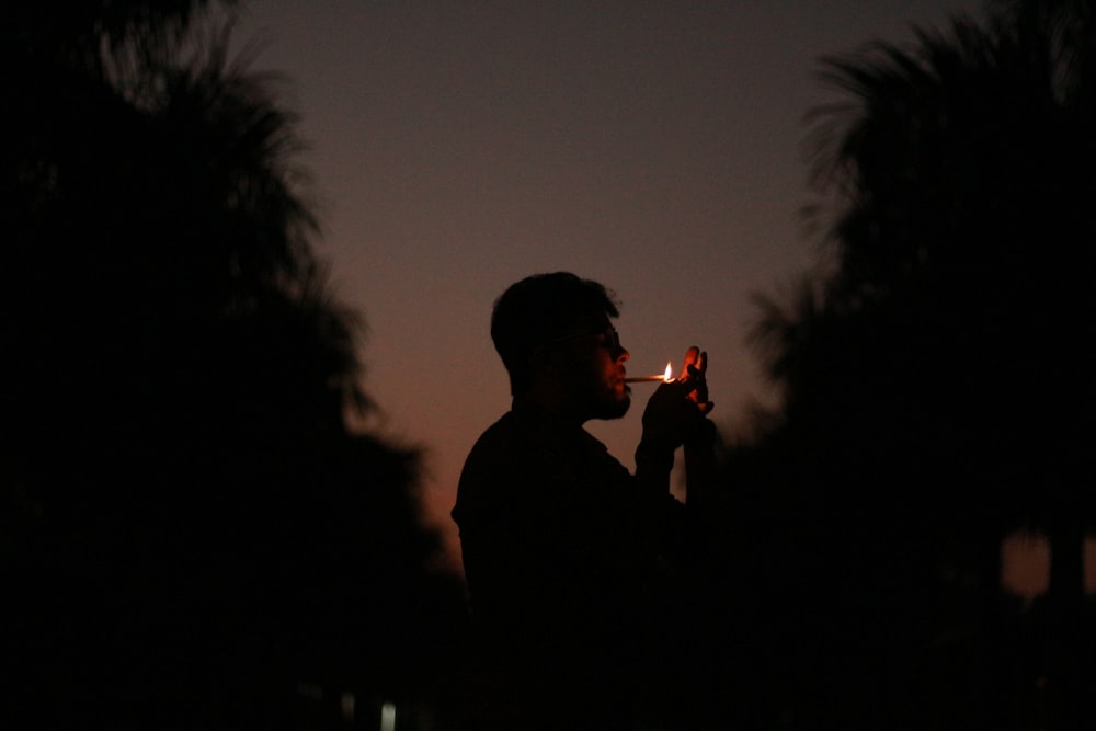 silhouette of man and woman kissing during night time