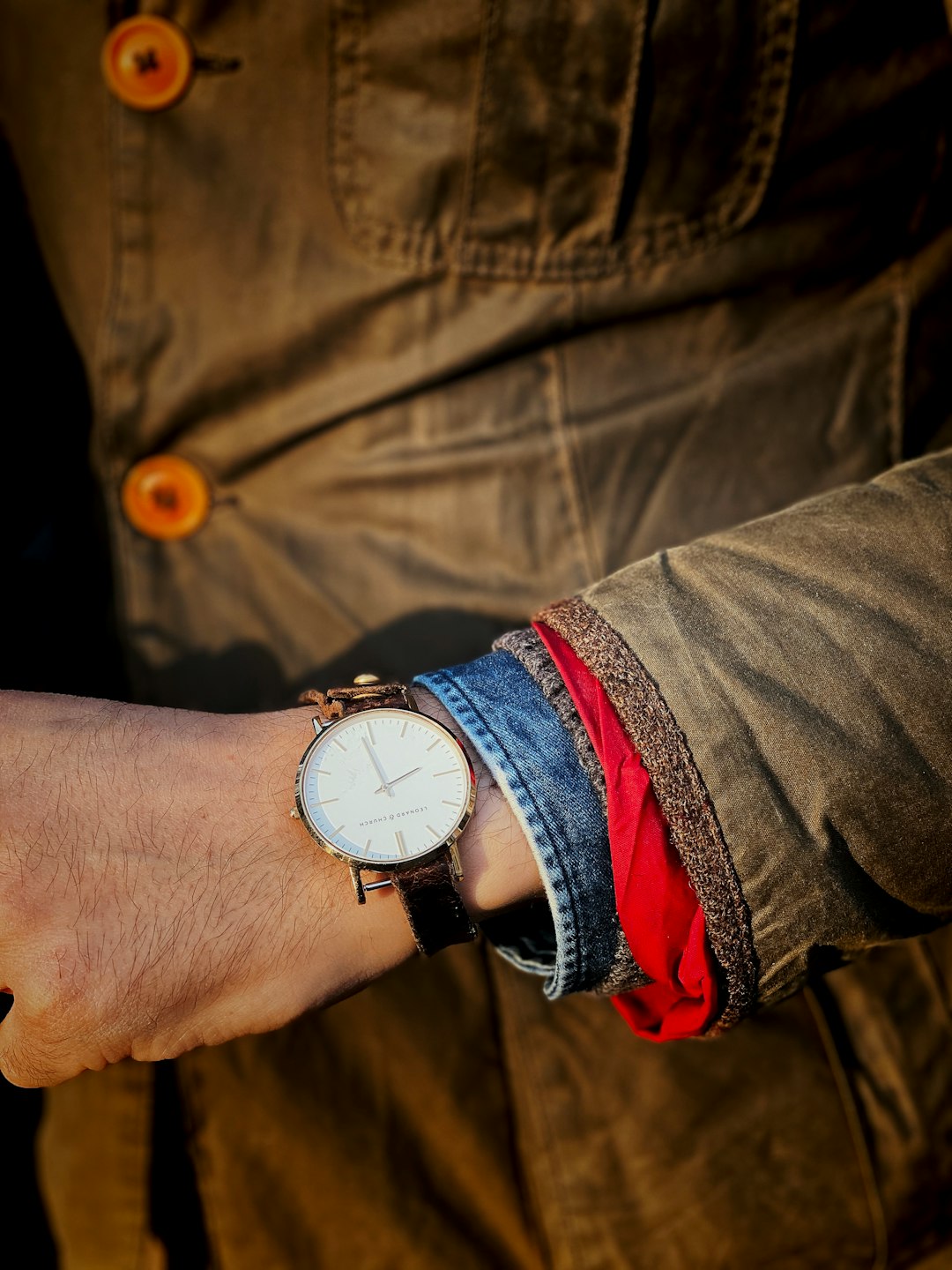 person wearing silver round analog watch