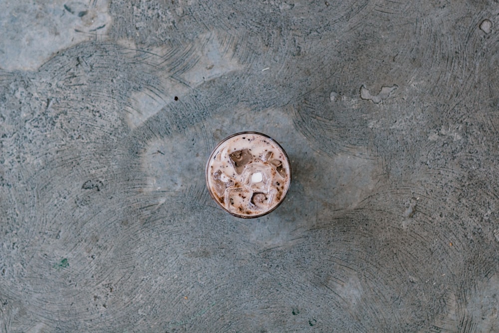 brown round ashtray on gray sand