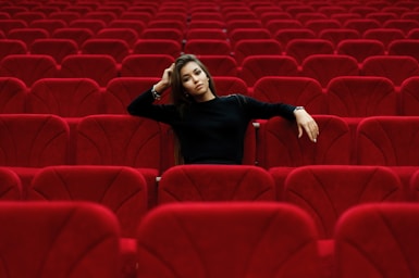 photography poses for women,how to photograph karina. ; woman in black long sleeve shirt sitting on red chair