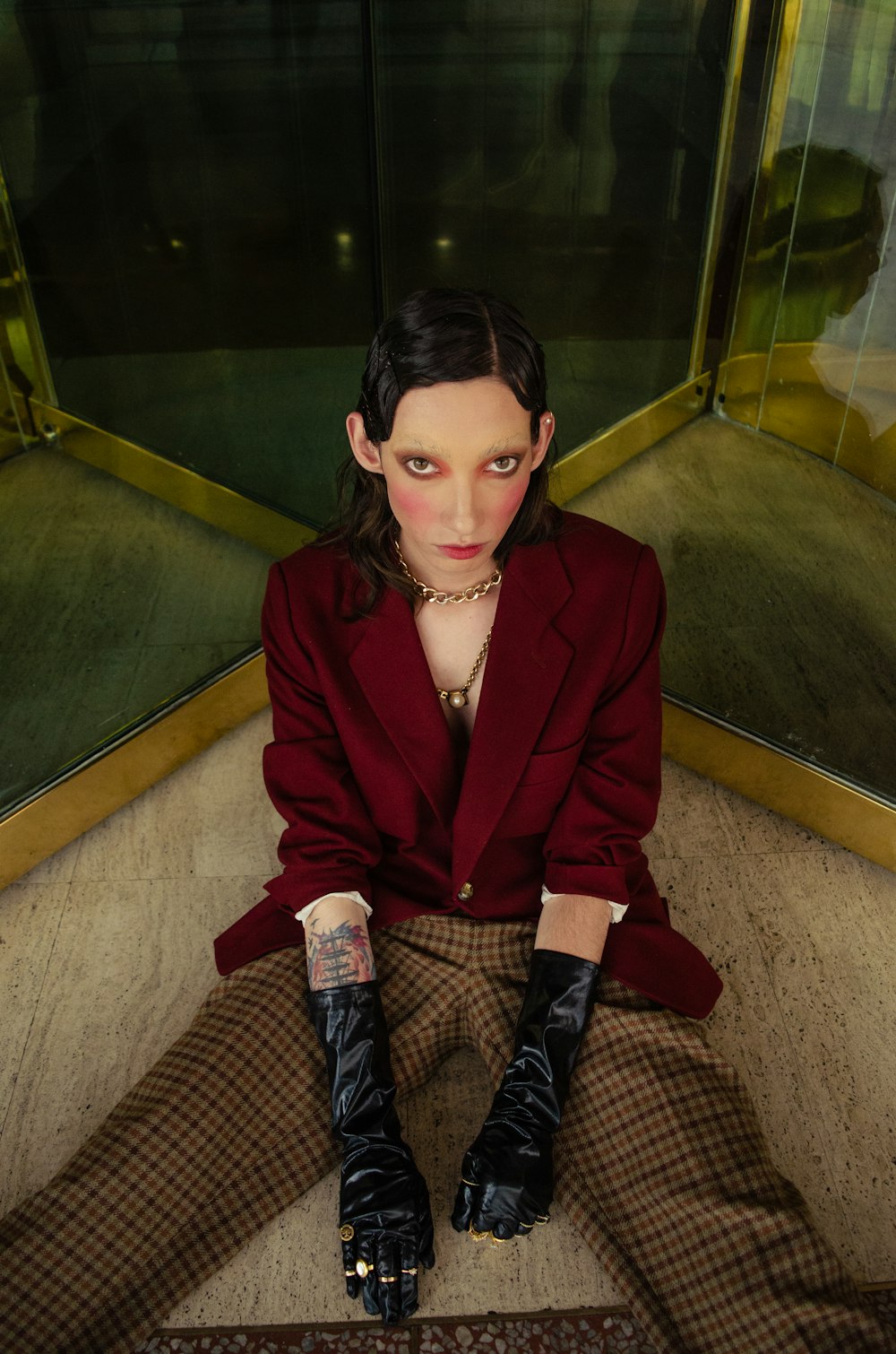 woman in red blazer sitting on stairs