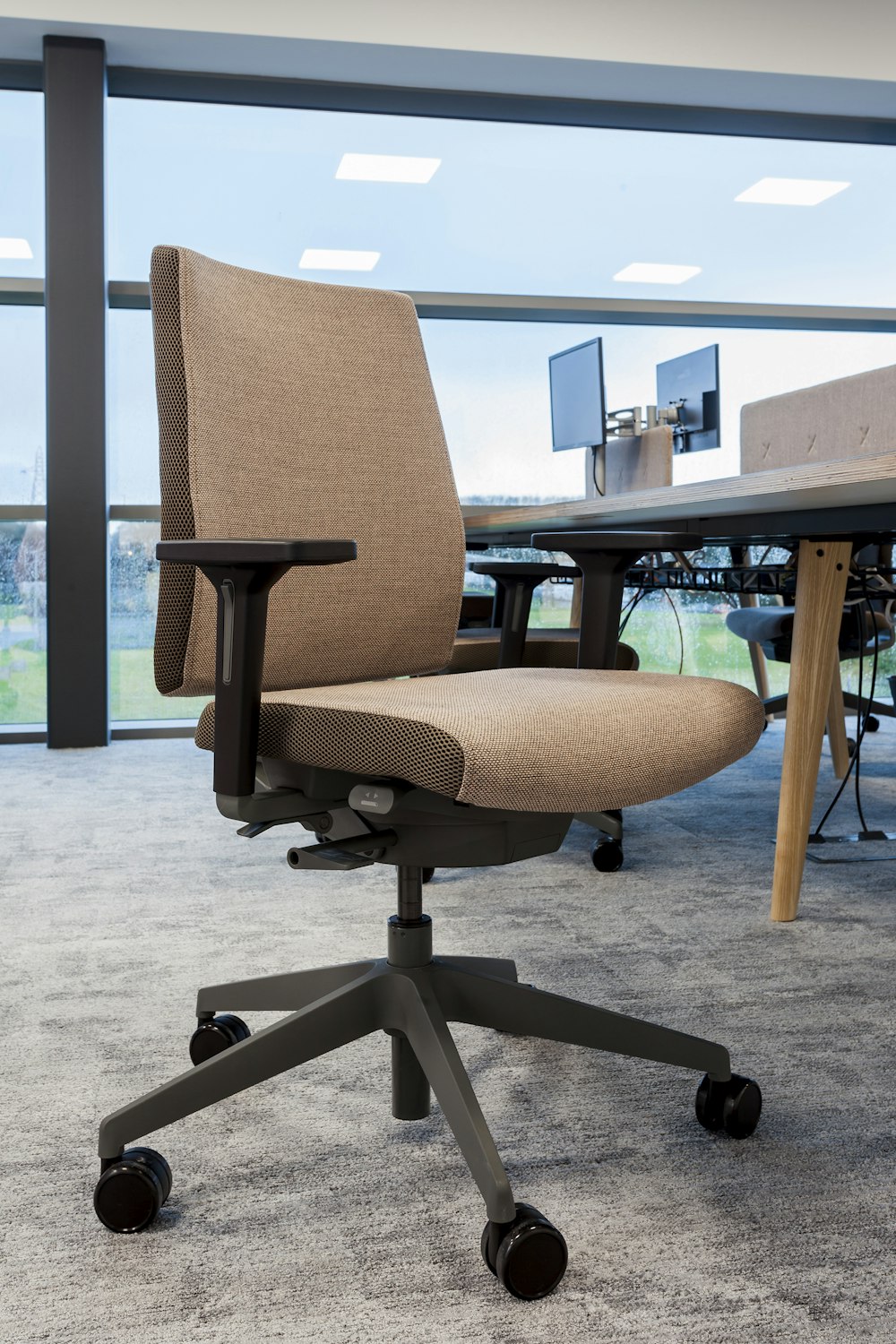 brown office rolling chair near table