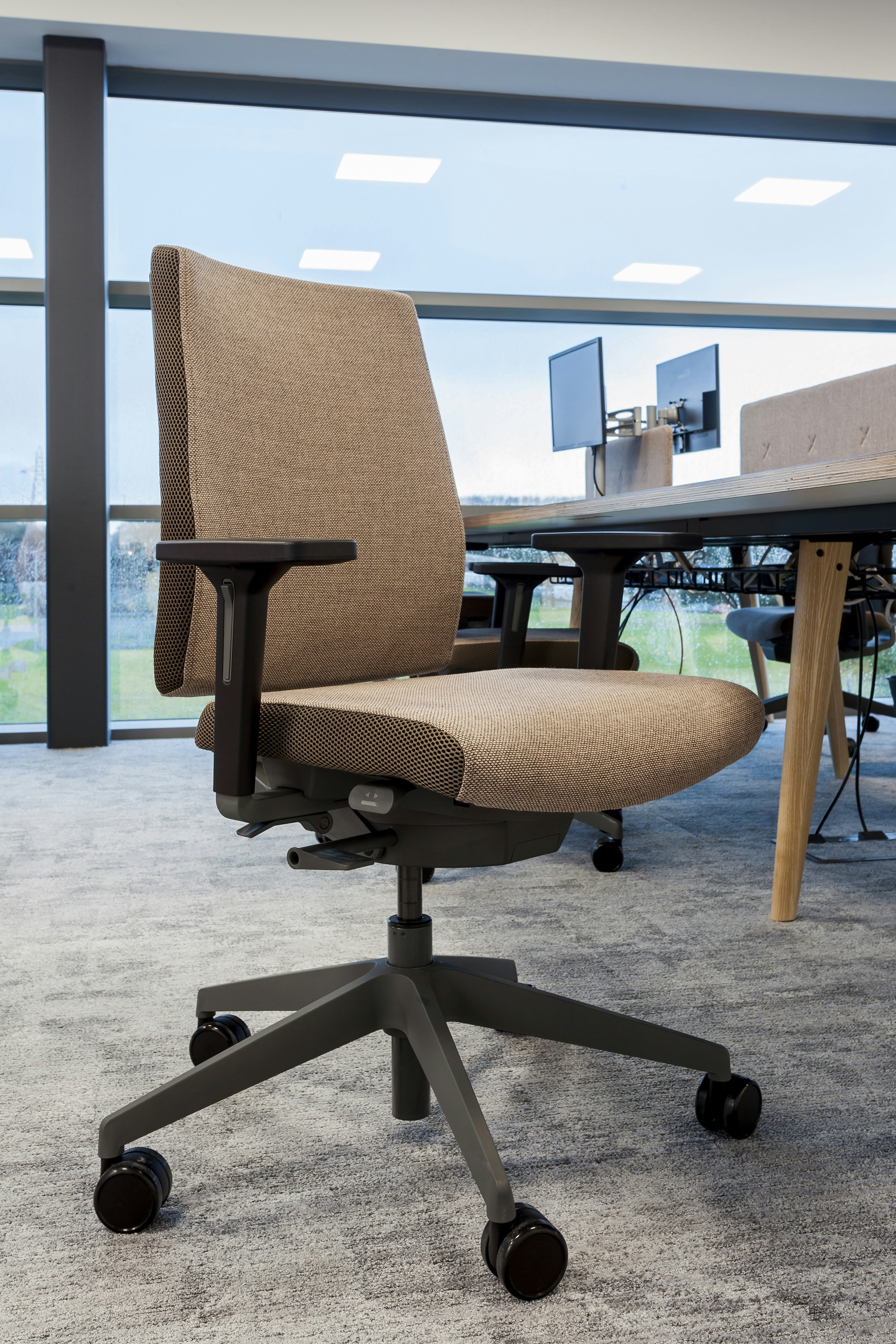 brown office rolling chair near table