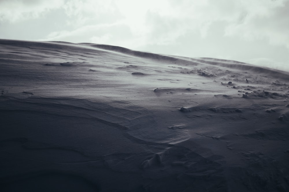 white sand under white clouds during daytime