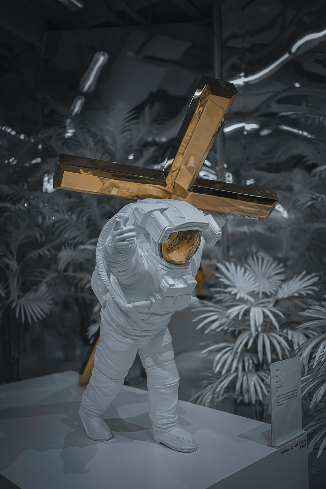 man in white suit holding brown wooden stand