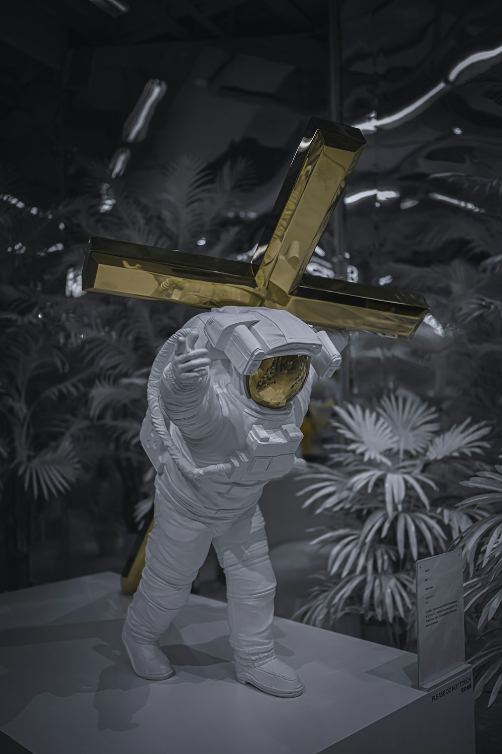 man in white suit holding brown wooden stand