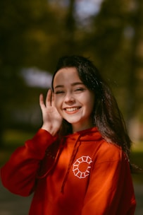 woman in red long sleeve shirt smiling