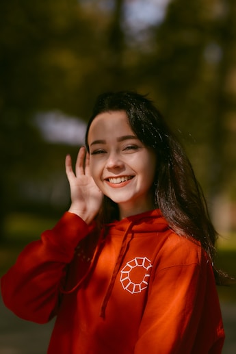 woman in red long sleeve shirt smiling