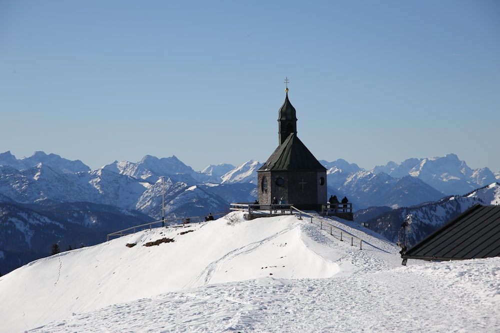 brown and white house on snow covered mountain during daytime