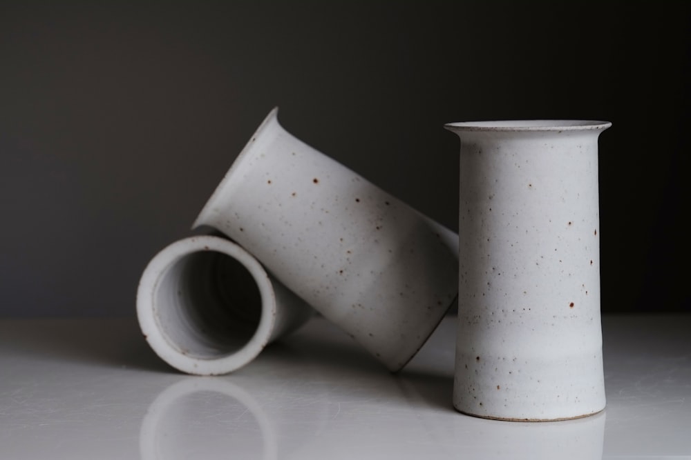 white and black ceramic mugs