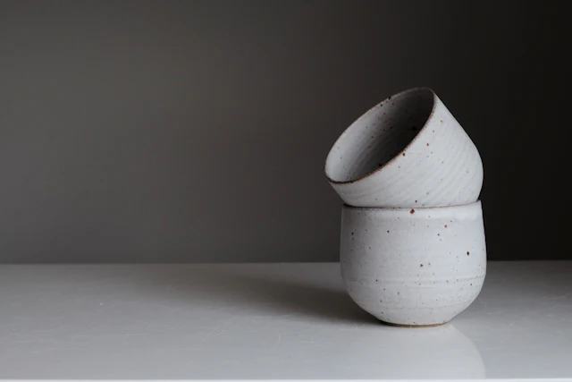 A sculptural ceramic vase on a quiet tabletop