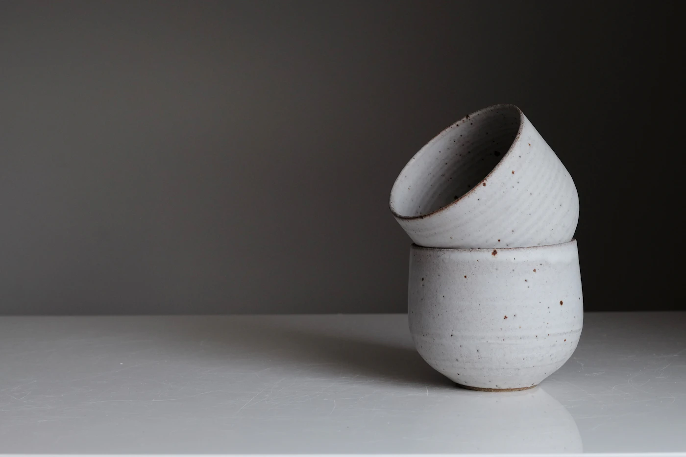 A sculptural ceramic vase on a quiet tabletop