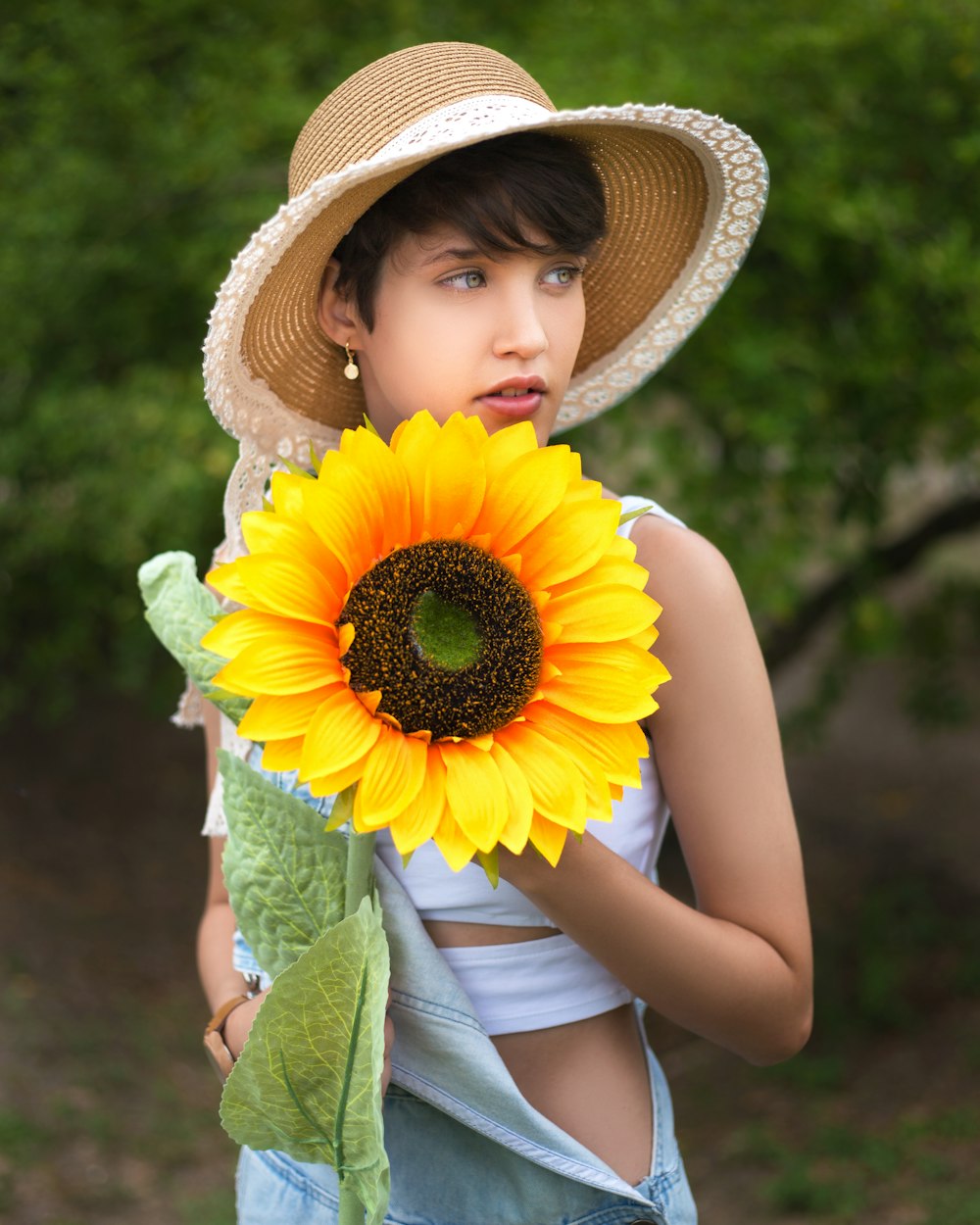 girl in yellow sun hat and white tank top