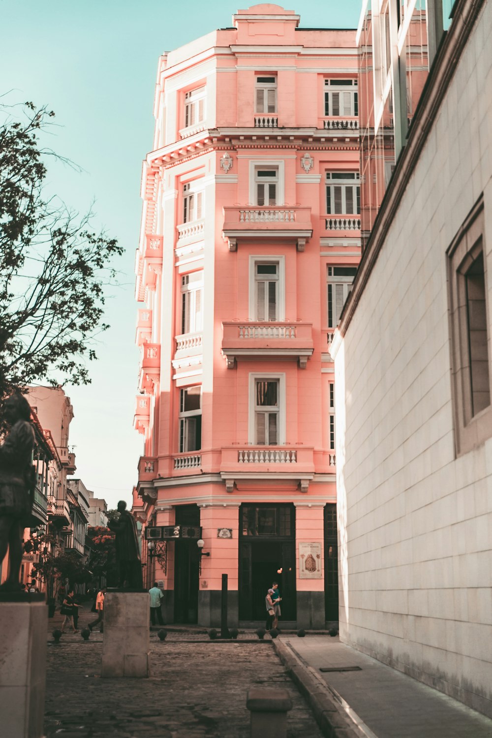 people walking on sidewalk near building during daytime