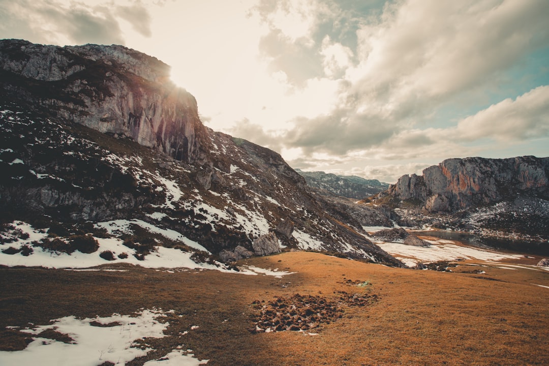 brown and gray rocky mountain under white cloudy sky during daytime